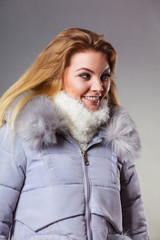 Woman wearing winter warm furry jacket