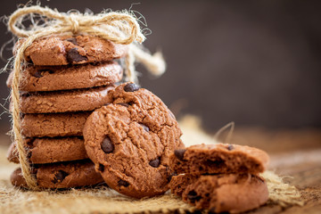 Still life of Close up stacked chocolate chip cookies on  napkin with rustic background