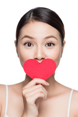 Attractive young woman with red heart. Valentine's day art portrait. Perfect make up