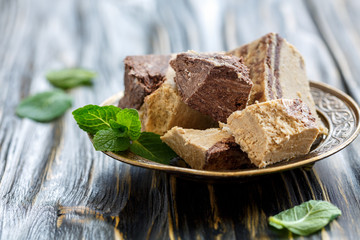 Tahini Halva with chocolate and mint on a bronze plate.