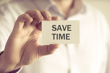 Businessman holding SAVE TIME message card