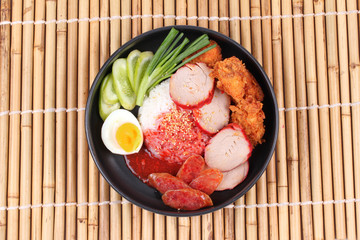 Jasmine rice with meat and boiled egg topped red sweet sauce .