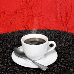 Black coffee and coffee beans with smoke on red cement wall.