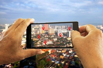 Hand holding smartphone seaching for location