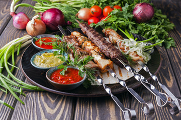 Different meats skewer with vegetables on wooden tray 