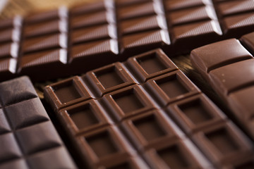 Chocolate bar, candy sweet, dessert food on wooden background