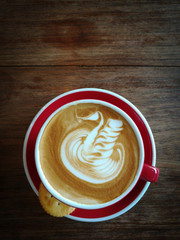 A cup of Latte Coffee with tea and cracker