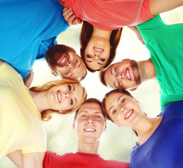 Group of smiling friends standing together. College, education, university: concept.