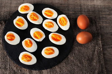 Halved  Eggs on wooden  background closeup