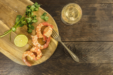 Glass of white wine with cooked shrimps and copyspace