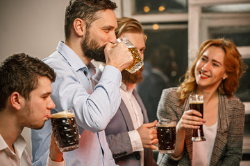 Group of friends enjoying evening drinks with beer