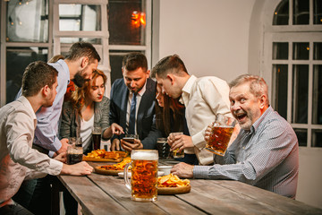 Group of friends enjoying evening drinks with beer