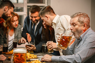 Group of friends enjoying evening drinks with beer