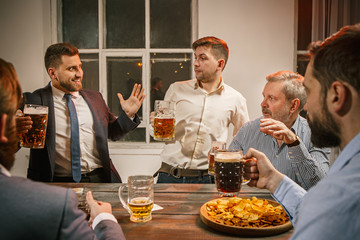 Group of friends enjoying evening drinks with beer