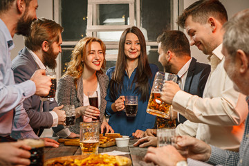 Group of friends enjoying evening drinks with beer