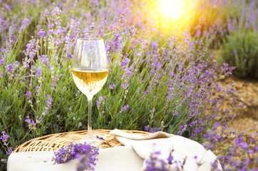 Wine glass against lavender landscape.