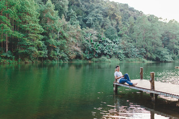 A man was relaxing on wooden bridge