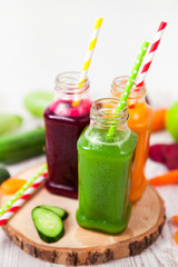 Obraz na płótnie Canvas Freshly squeezed vegetable juice in bottles, useful vitamin cocktail, detox diet, selective focus