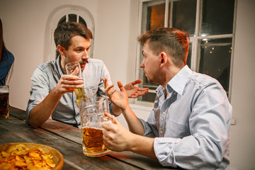 Group of friends enjoying evening drinks with beer
