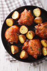 BBQ Food: maple chicken thighs and baby potatoes close-up. vertical top view