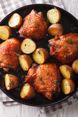Maple chicken thighs and baby potatoes close-up. vertical top view