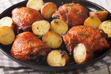 Maple chicken thighs and baby potatoes close-up. horizontal