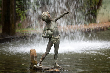 Fototapeta na wymiar Statue of boy in botanical garden Monte of Funchal, Madeira. Portugal.
