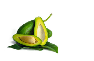 Whole avocado with leaves and cut half seed isolated on white background as package design element