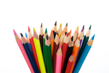 Heap of pencils on the white surface with backlight.