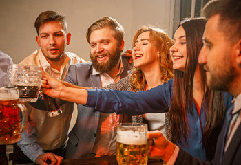 Group of friends enjoying evening drinks with beer
