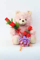 Teddy bears, pink and red roses and gift box on a white background.