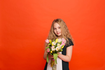 Beautiful girl with a bouquet of tulips