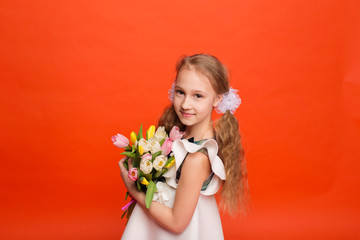 Obraz na płótnie Canvas Beautiful girl with a bouquet of tulips