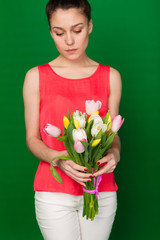 Beautiful girl with a bouquet of tulips