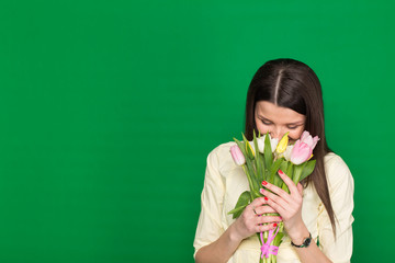 Beautiful girl with a bouquet of tulips