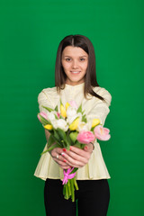Beautiful girl with a bouquet of tulips