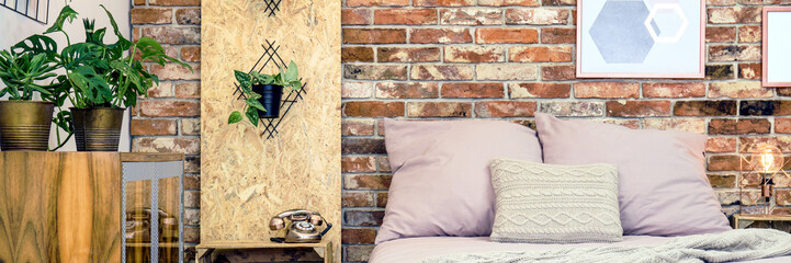 Bed against brick wall