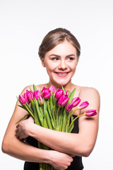 Portrait of beautiful young woman with long hair and glamour makeup. Girl holding tulips. Studio shot.