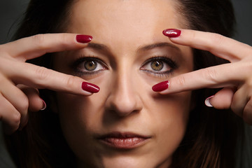 Portrait of beautiful woman with red nails.