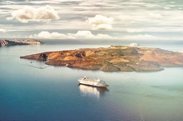 Poster Beautiful landscape with sea view. Cruise liner at the sea near the Nea Kameni, a small  Greek island in the Aegean Sea near Santorini, cyclades, Greece © alekosa