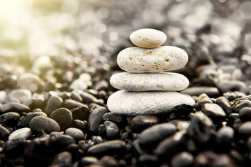 Fototapeta na wymiar Stones pyramid on the beach. Zen and harmony concept.