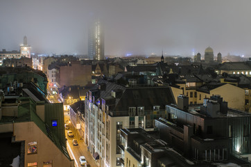 illuminated street in central part of Riga on a foggy winter evening seen from above