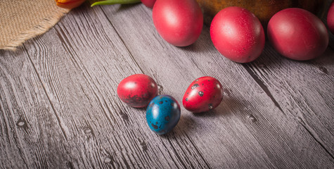 Easter eggs and tulips on wooden background