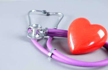 Red heart and a stethoscope on white background