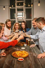 Group of friends enjoying evening drinks with beer