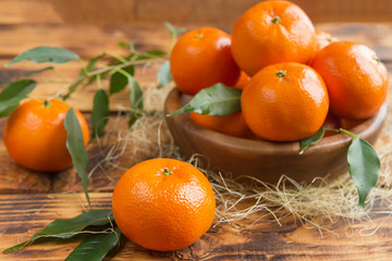 Fresh citrus fruits tangerines, oranges closeup in rustic style