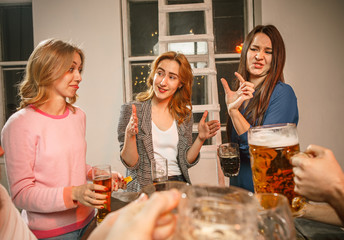 Group of friends enjoying evening drinks with beer