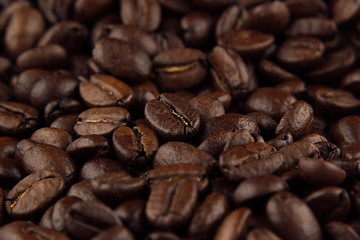 Roasted coffee beans closeup top view as background.