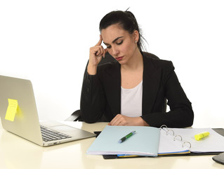 attractive woman in business suit working tired and bored in office computer desk looking sad