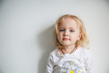 Naklejka premium Portrait of a emotional beautiful little girl. Isolated on white background.